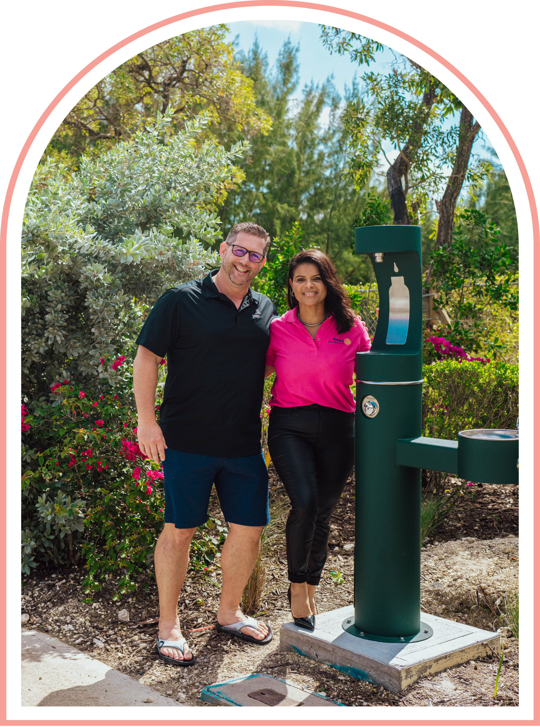 People posing next to water fountain