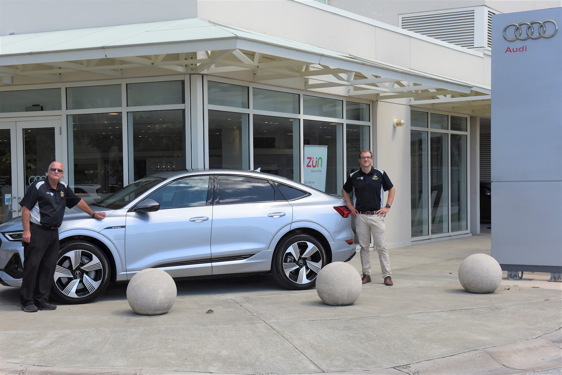 Audi sales representatives with the new electric car