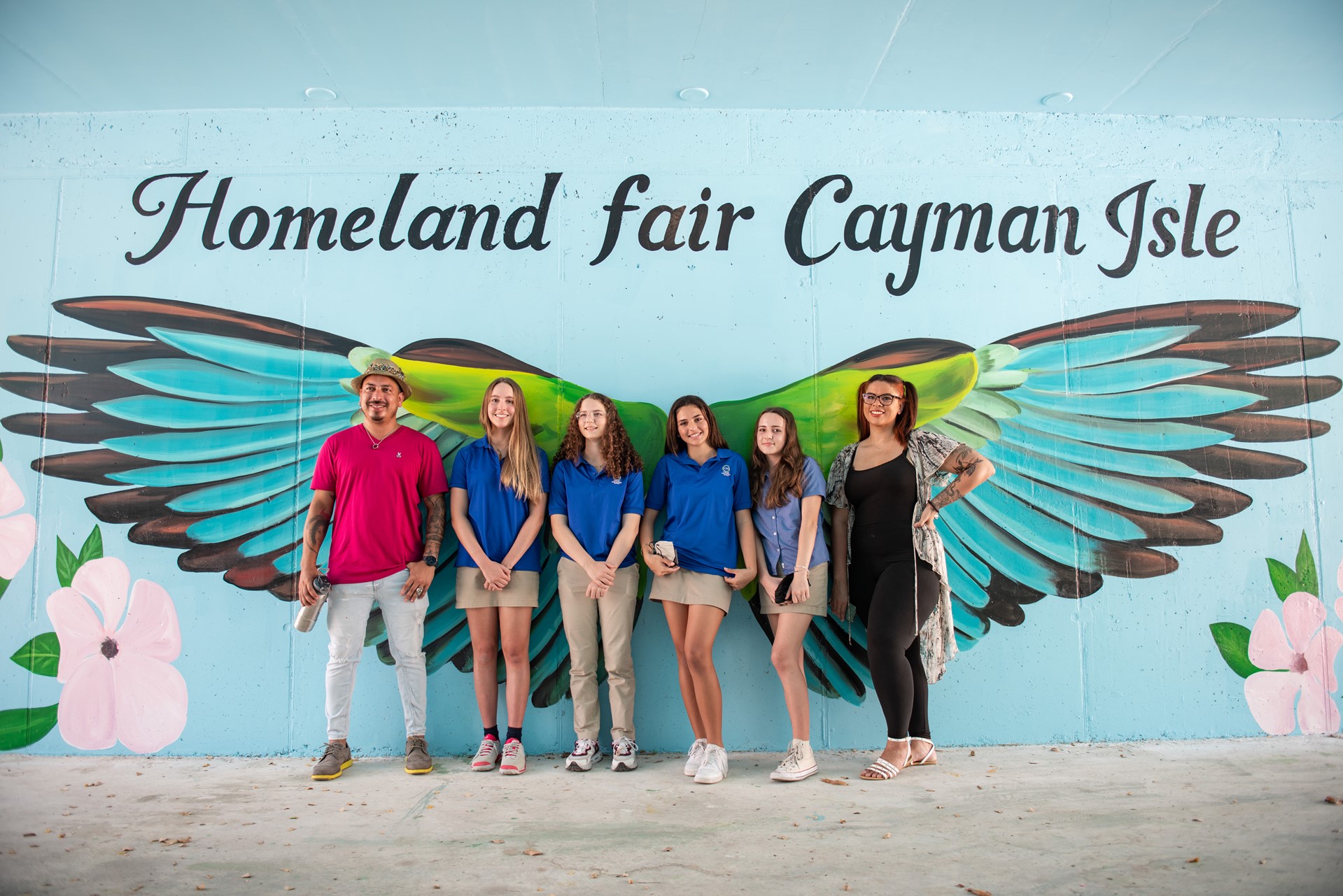 artists in front of mural