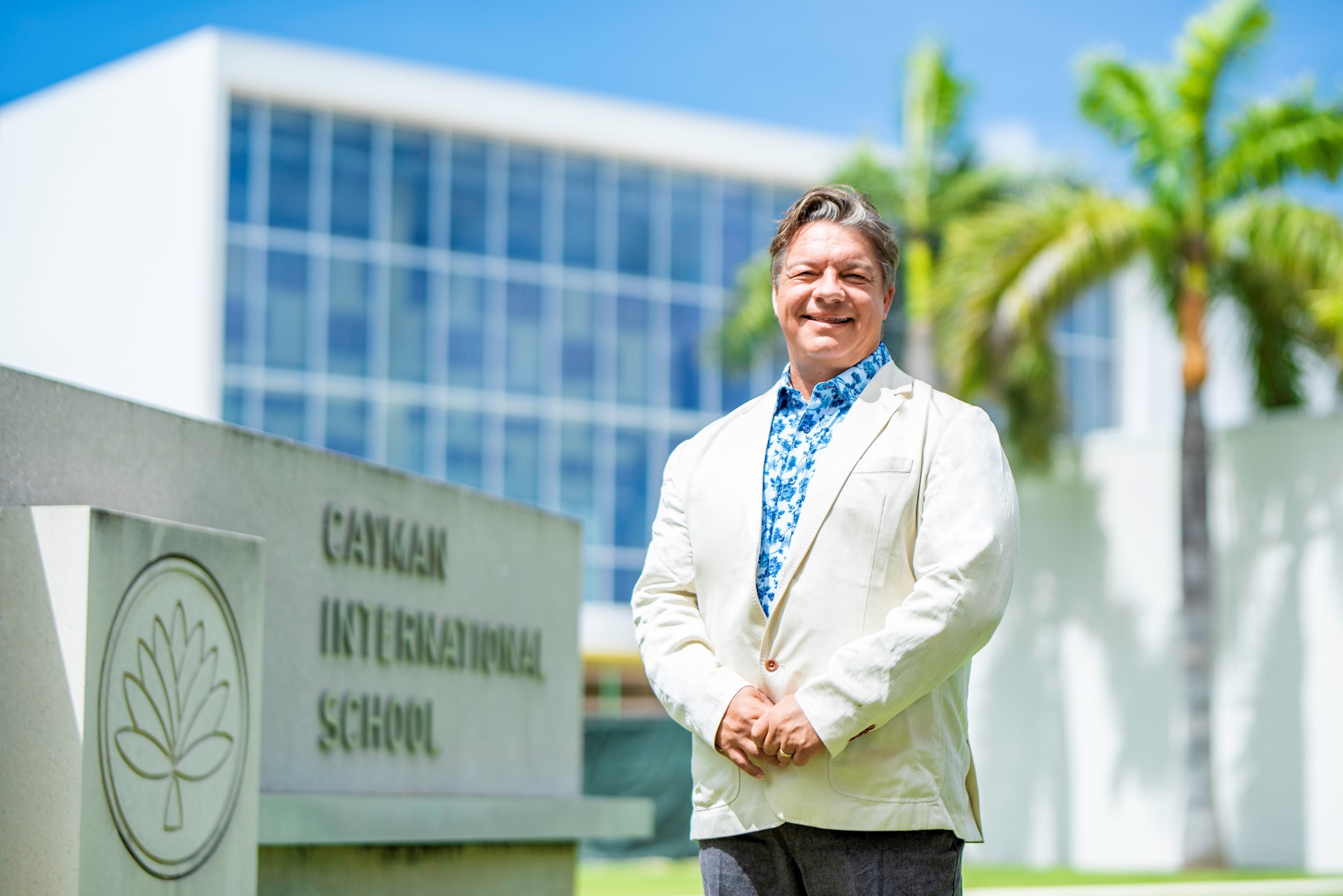 director of school in front of sign