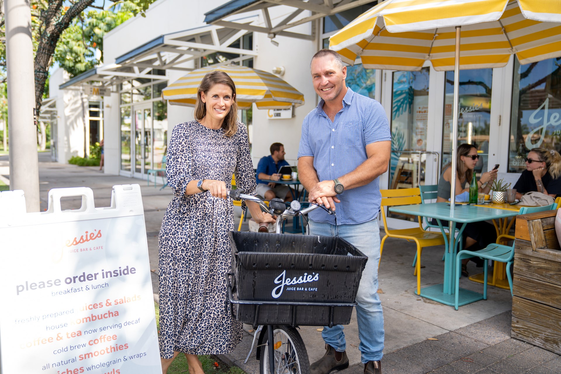 couple with bike outside juice bar