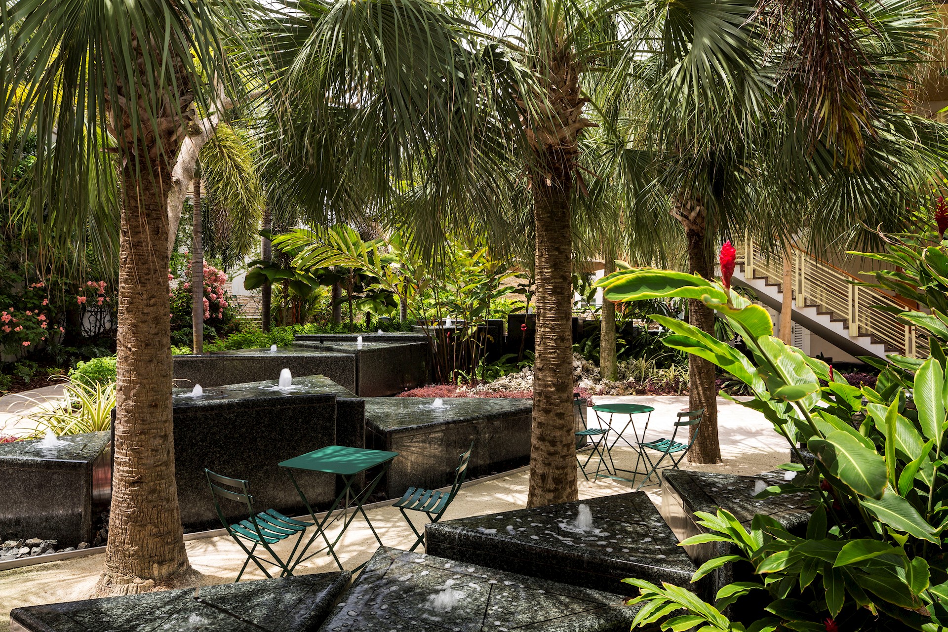 shaded-courtyard-with-palm-trees-fountains-and-benches