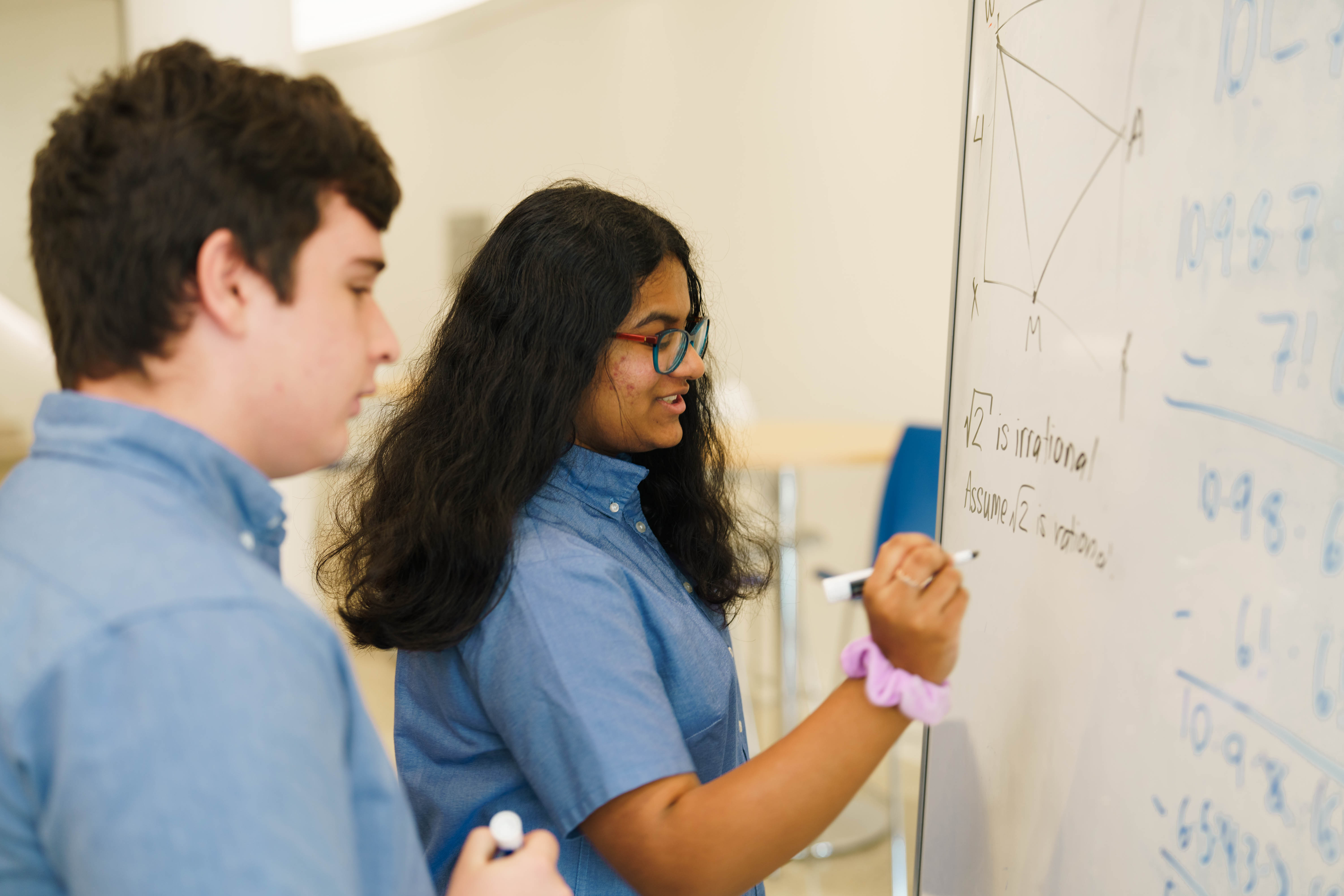Students writing on whiteboard