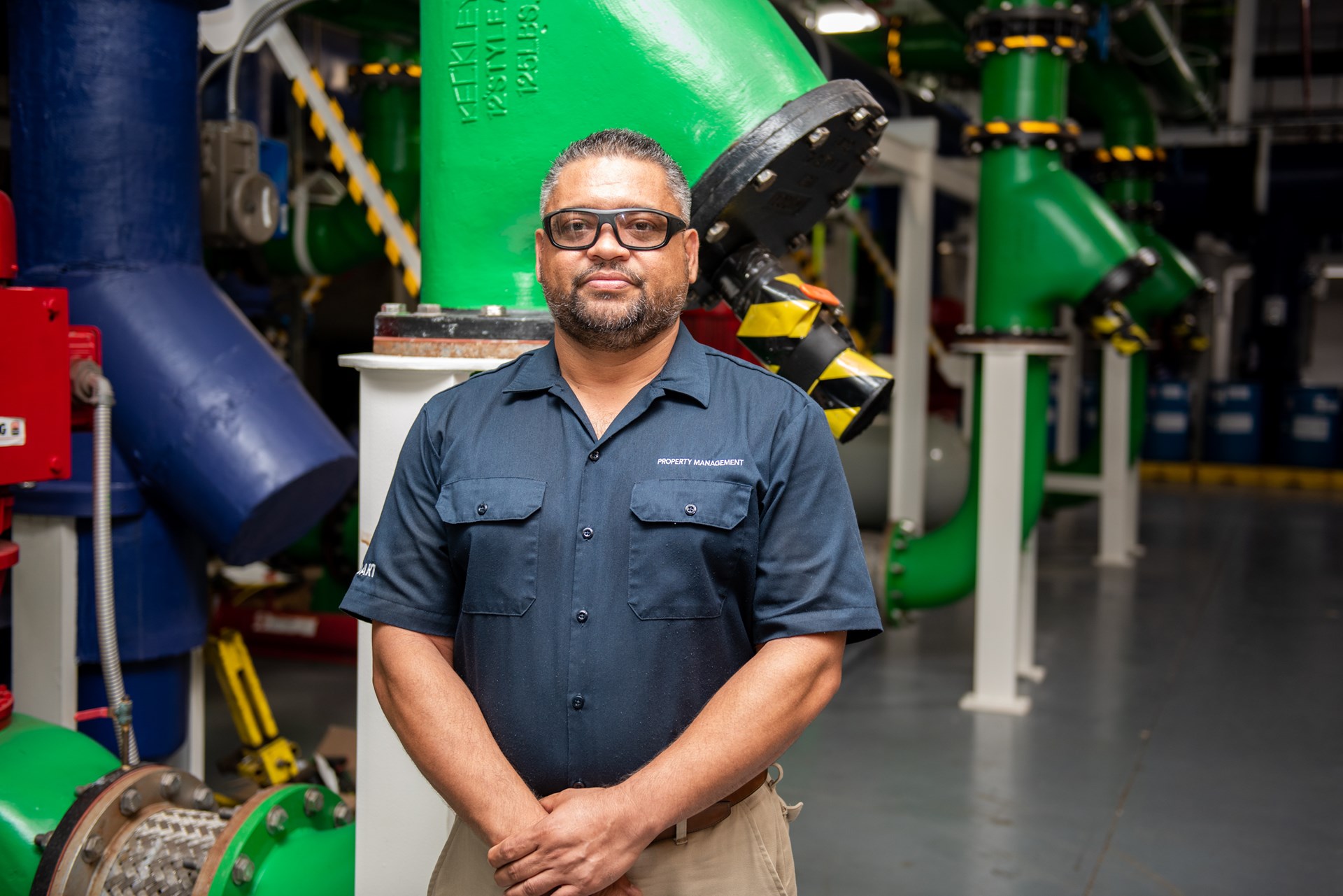 Man of colour standing in front of green thermal units