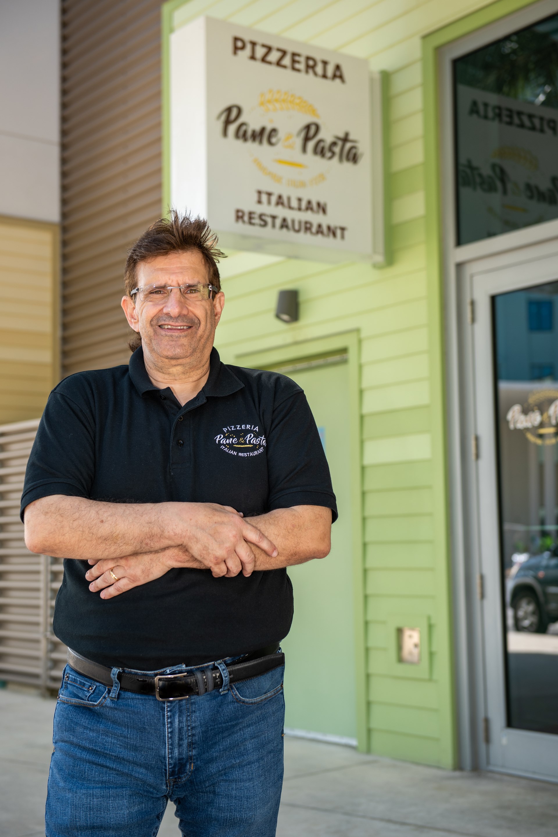 Man stands in front of sign 