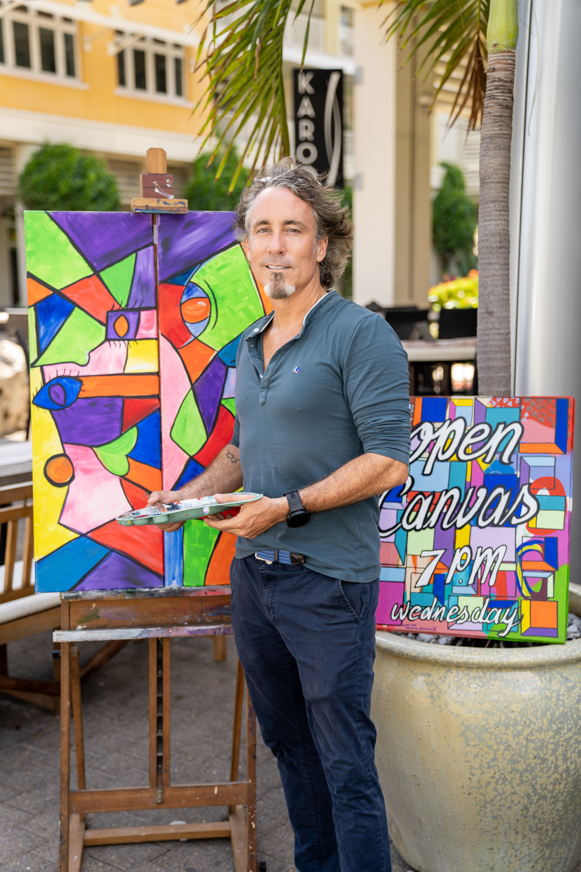 Man stands in front of artwork 
