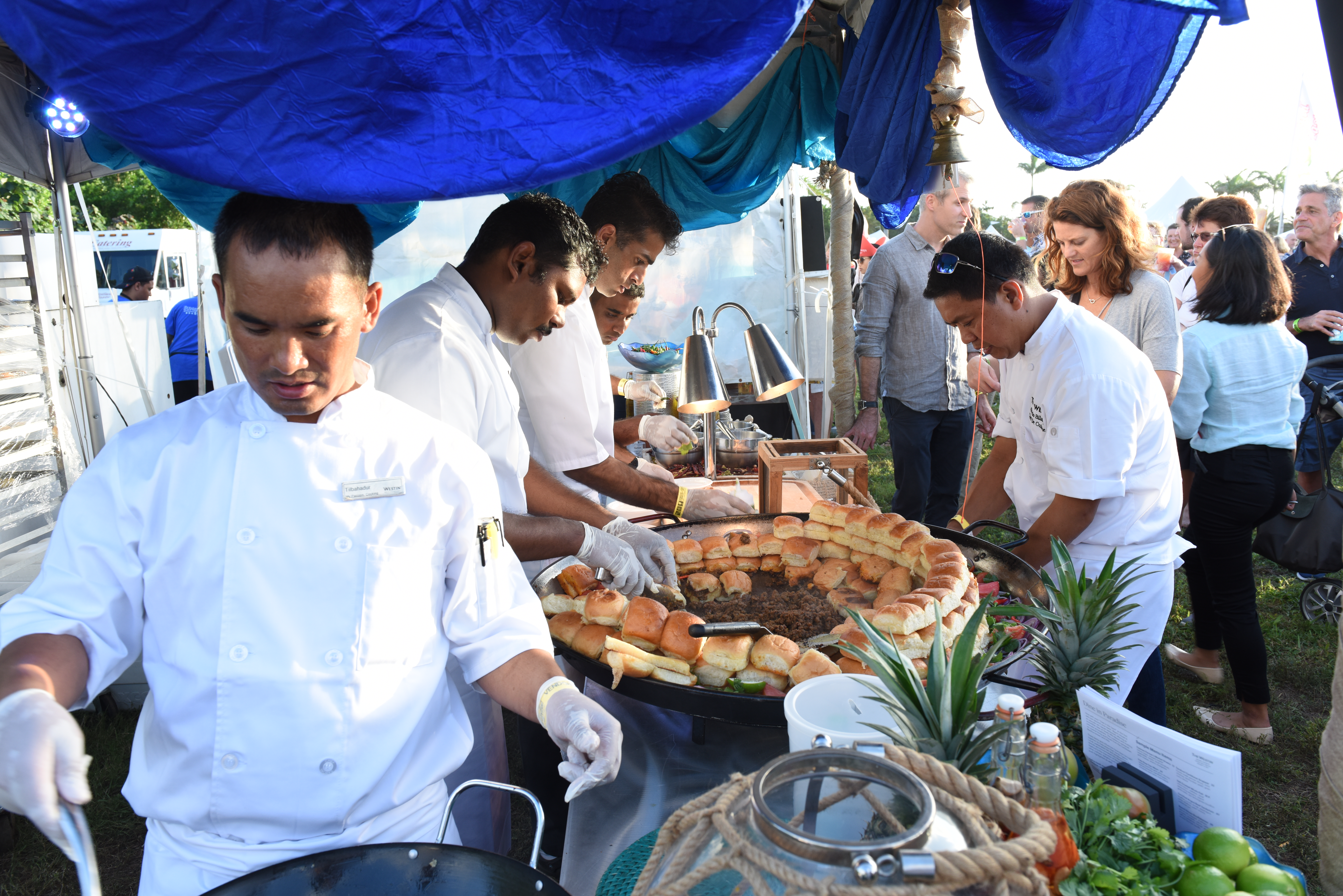 chefs serving food to customers at food festival