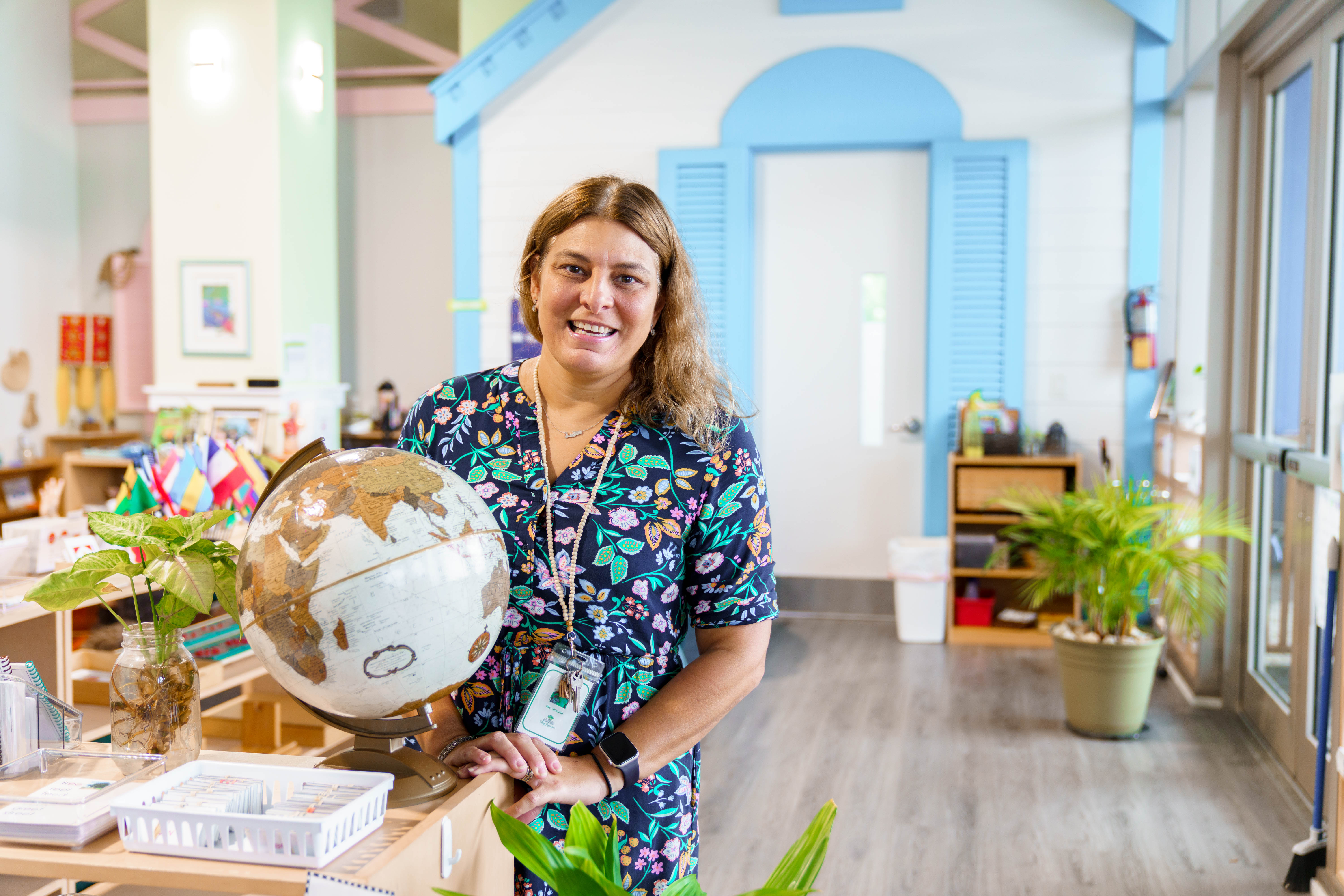 Woman posing next to globe