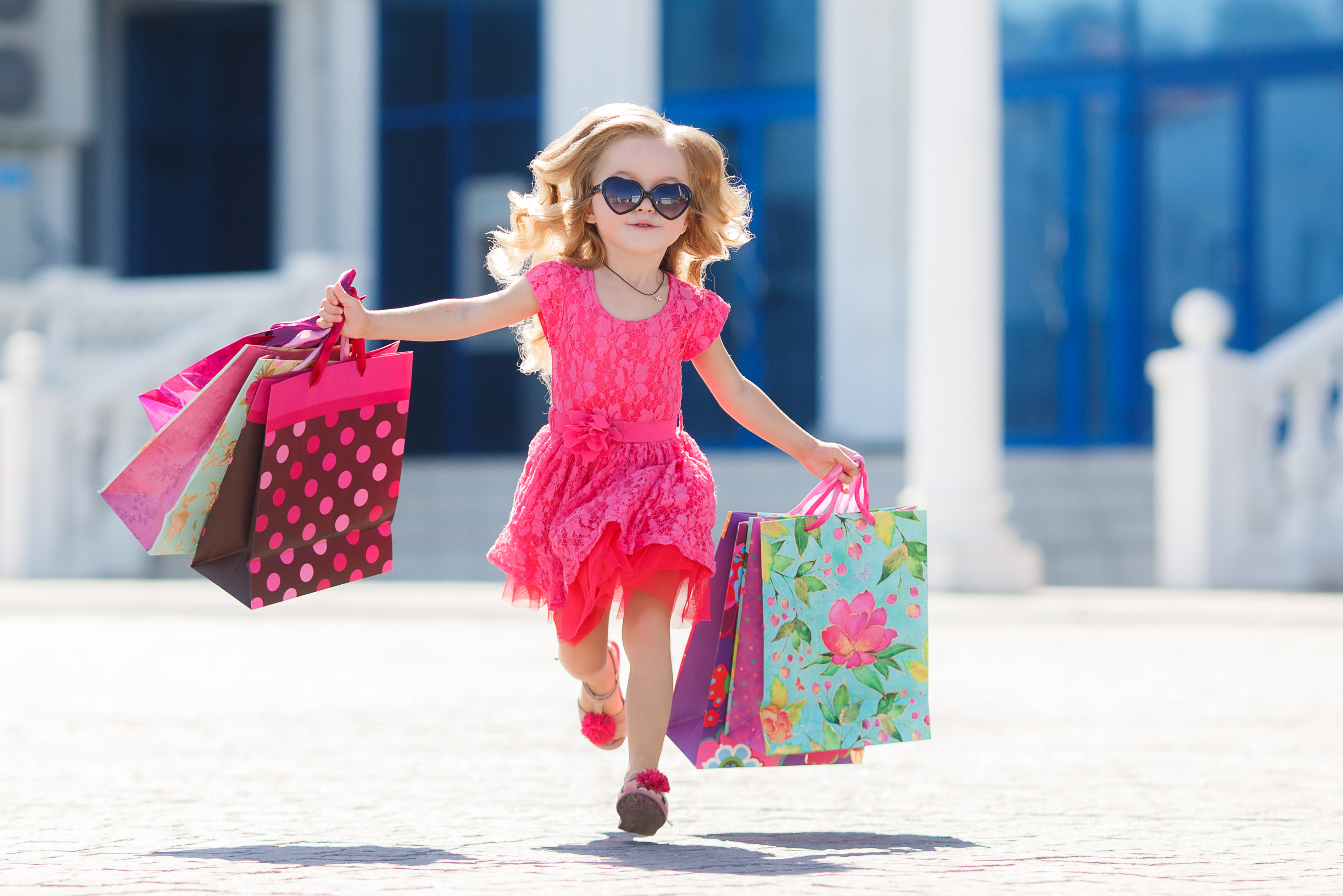little girl with shopping bags