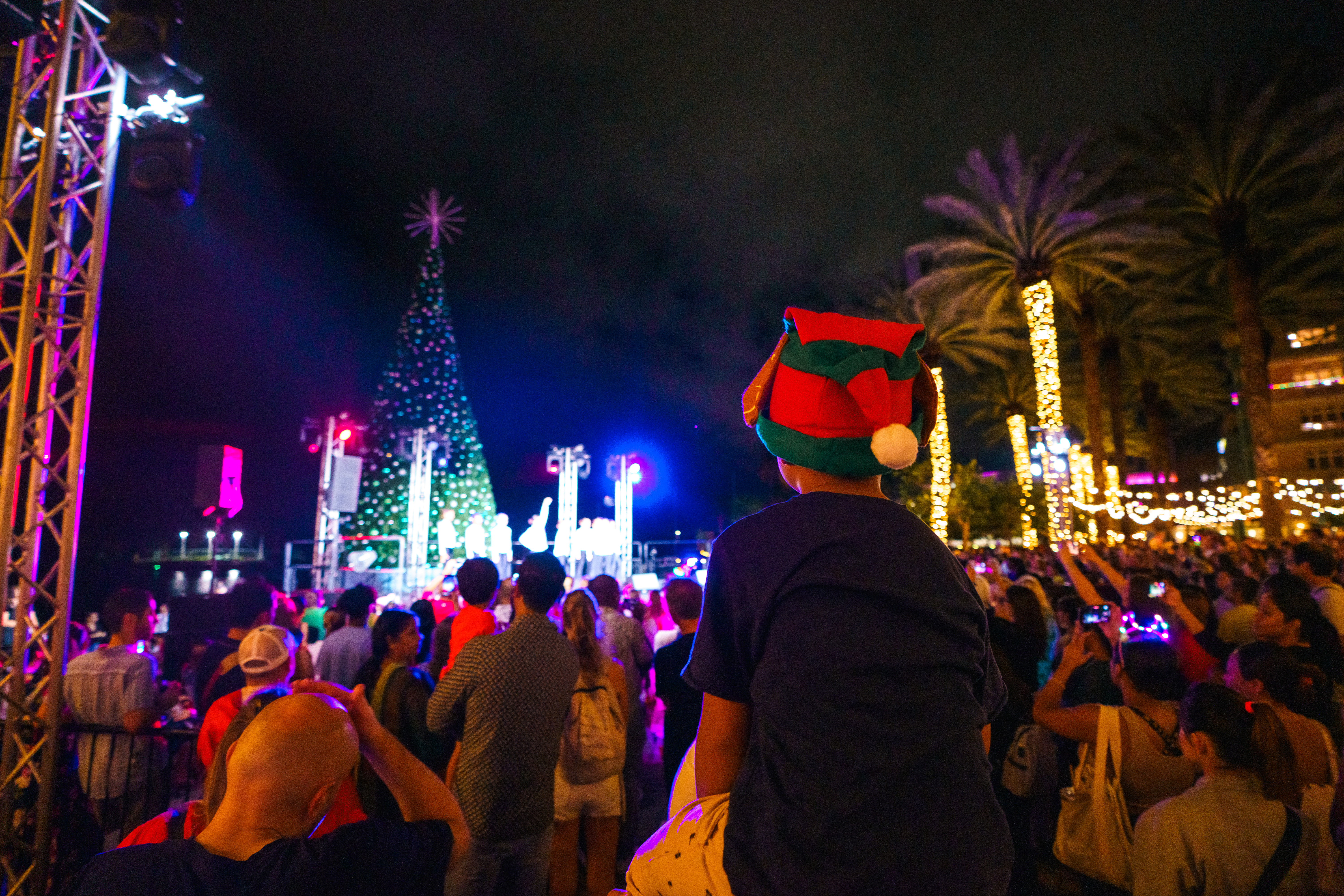 Crowd gathered in front of Camana Bay tree