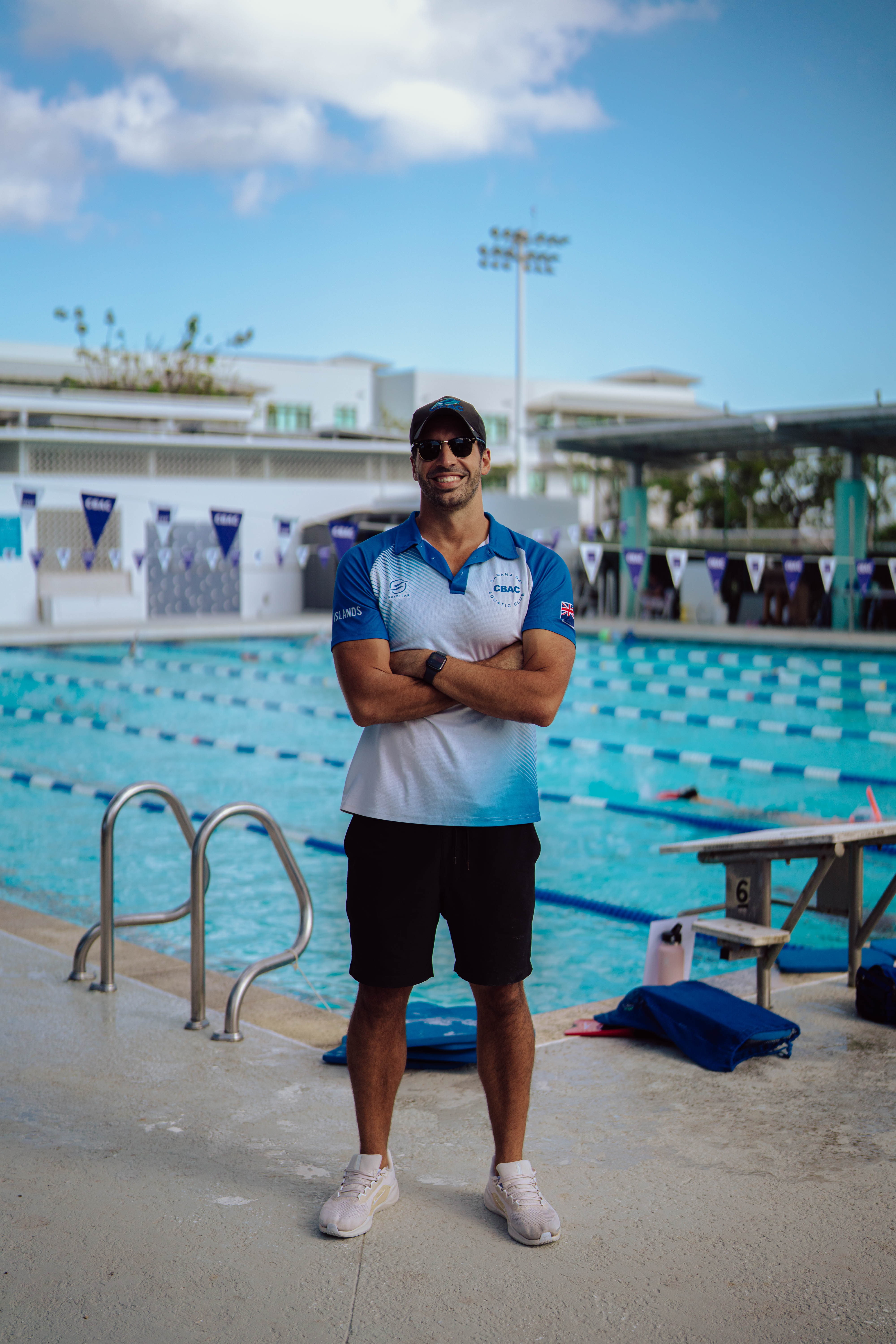 Swim coach standing in front of pool