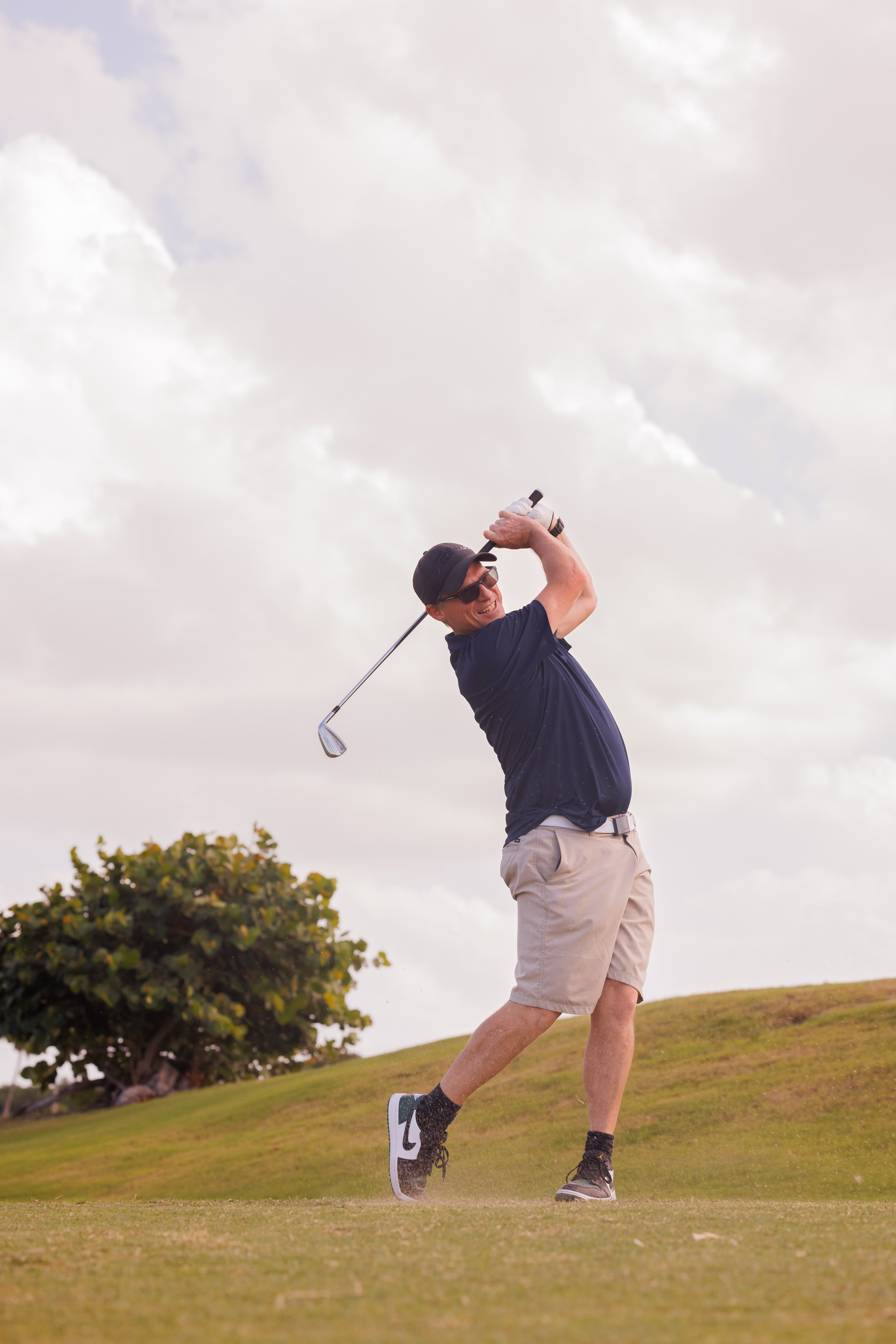 man swings golf club