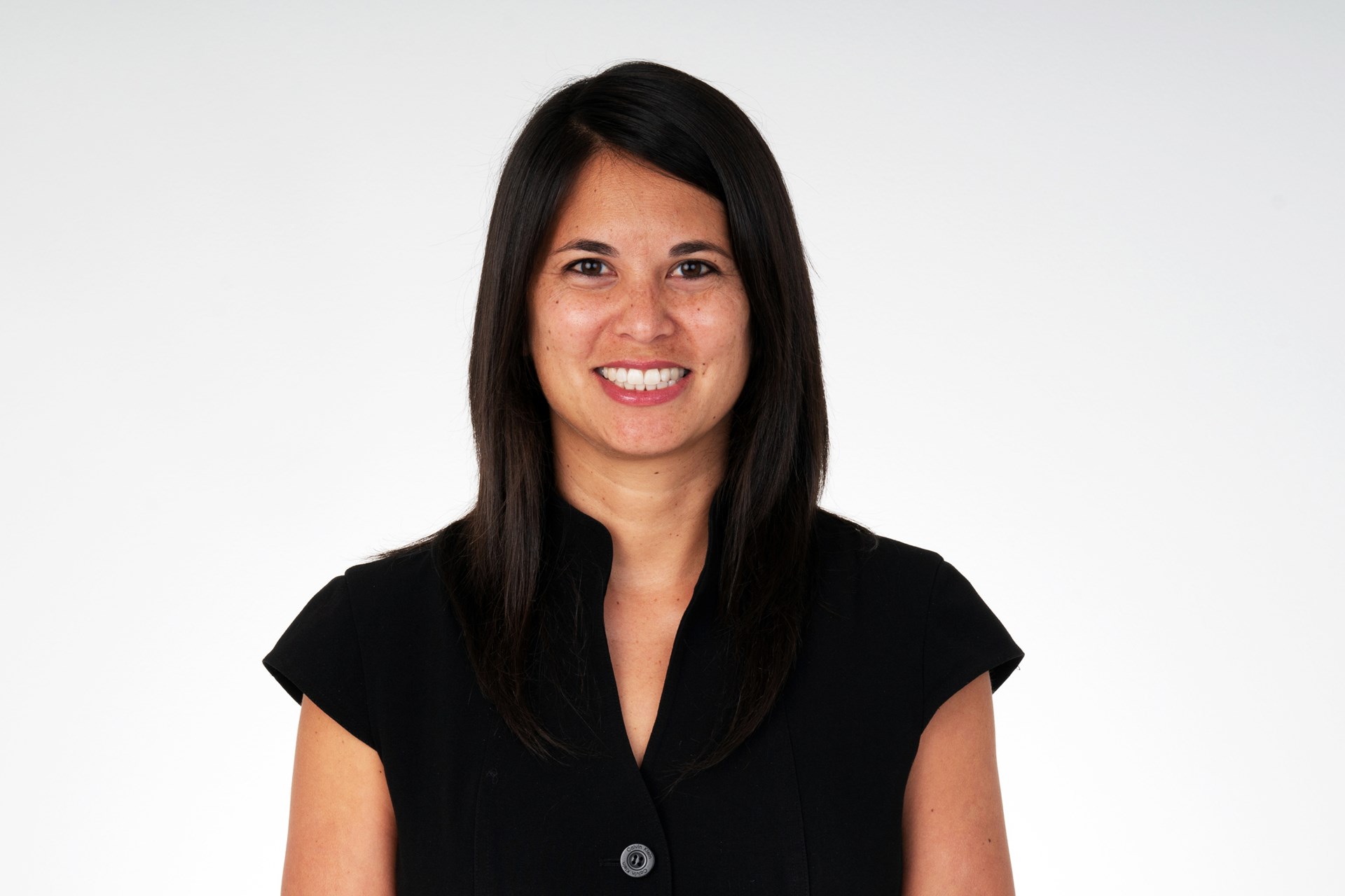 Woman in black shirt smiling at camera